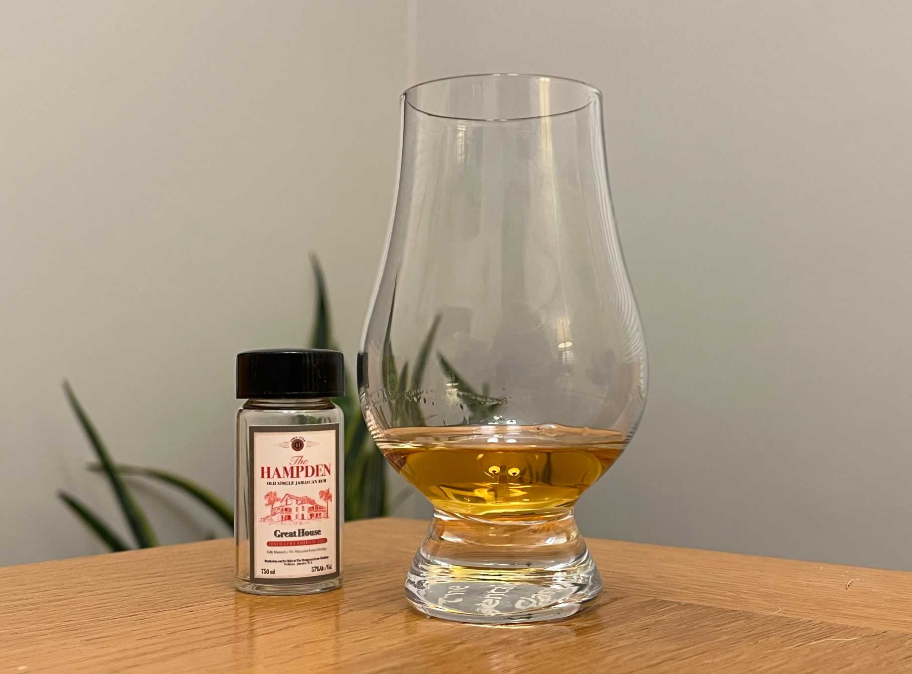 A bottle of Hampden Great House 2024 next to a glass of rum