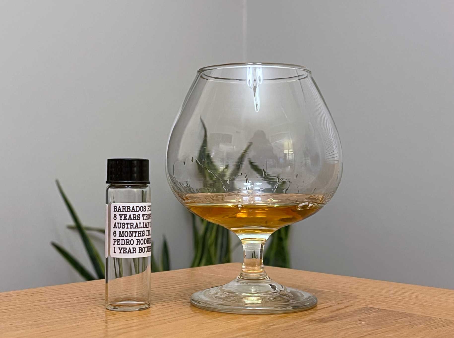 A bottle of Dead Reckoning Barbados PX Cask next to a glass of rum