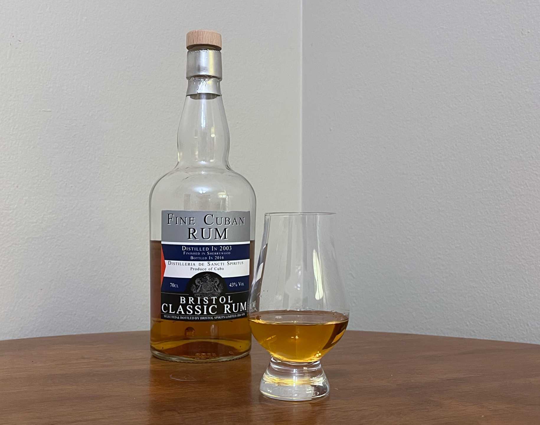 A bottle of Bristol Fine Cuban Rum next to a glass of rum