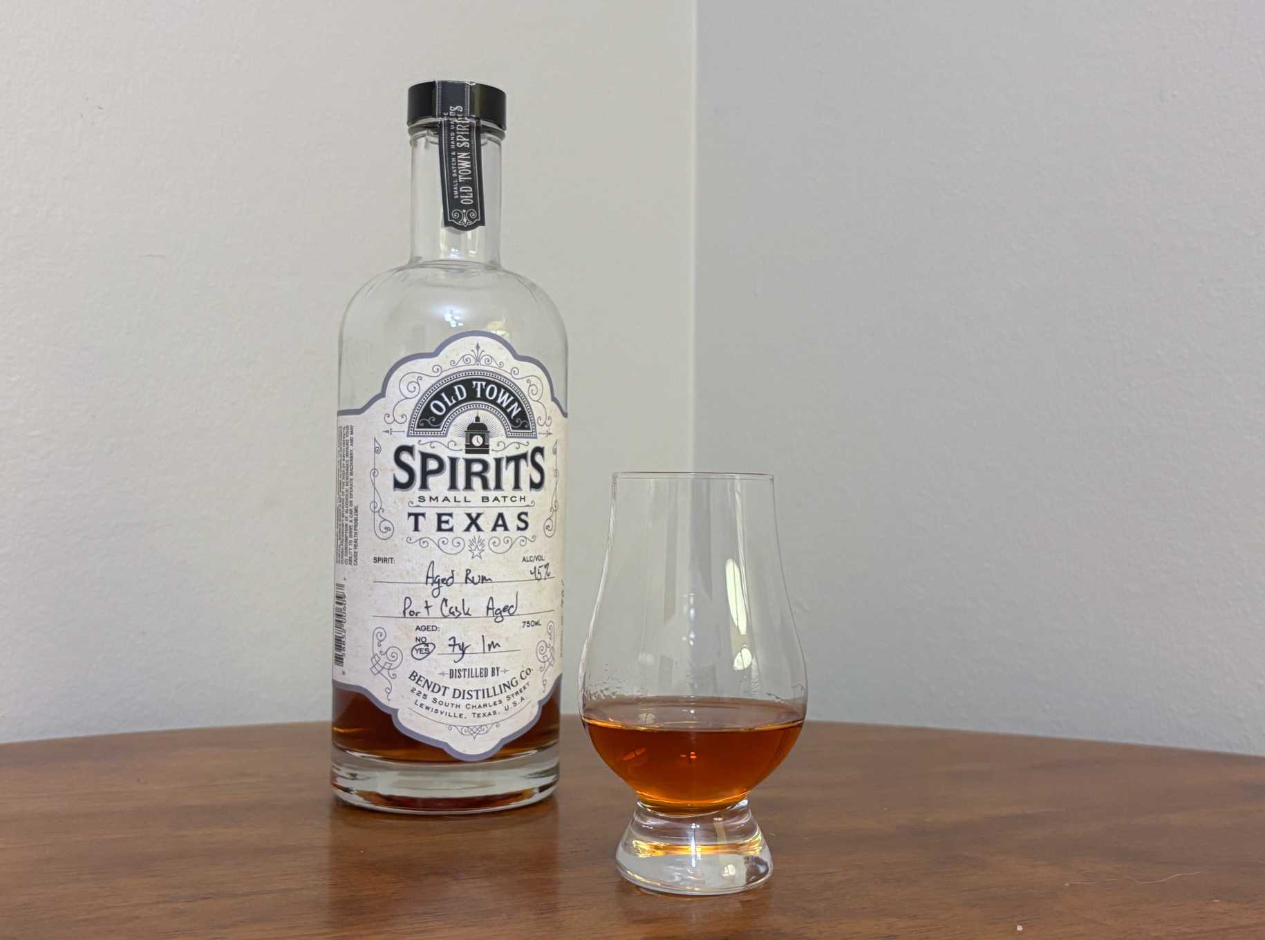 A bottle of Old Town Spirits 7 year Port Cask next to a glass of rum