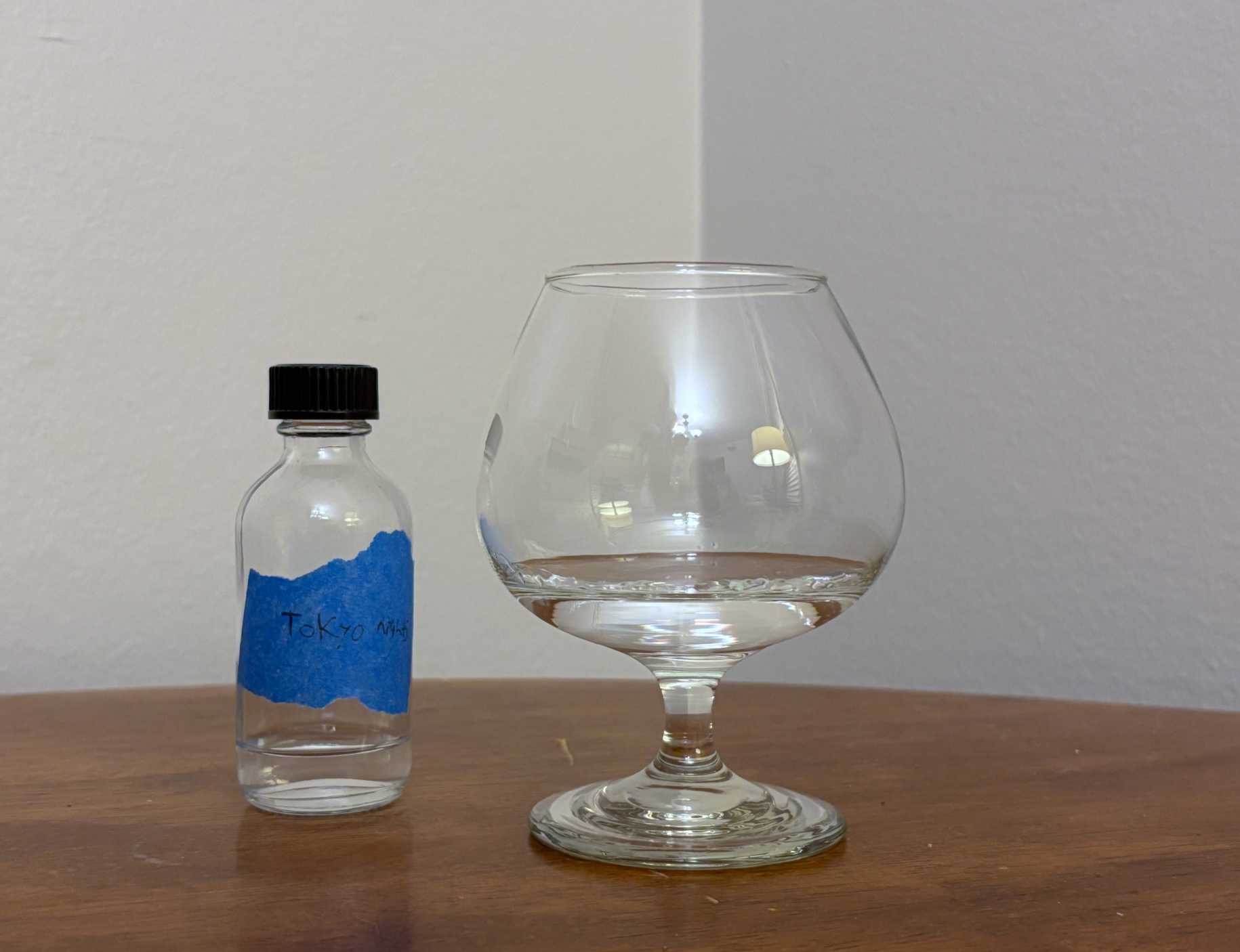 A bottle of Tokyo Nights next to a glass of rum