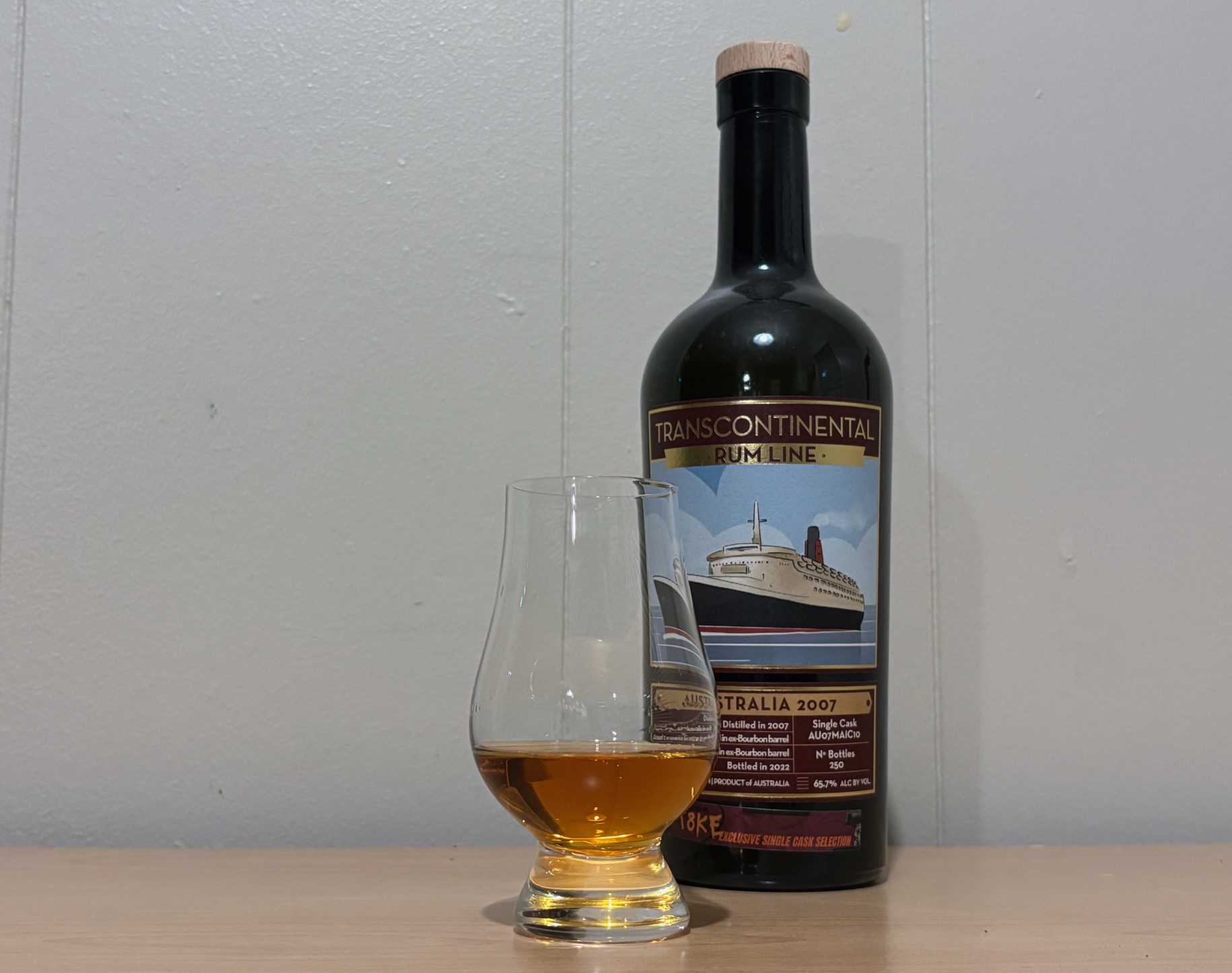 A bottle of Transcontinental Rum Line Australia 2007 Single Cask next to a glass of rum