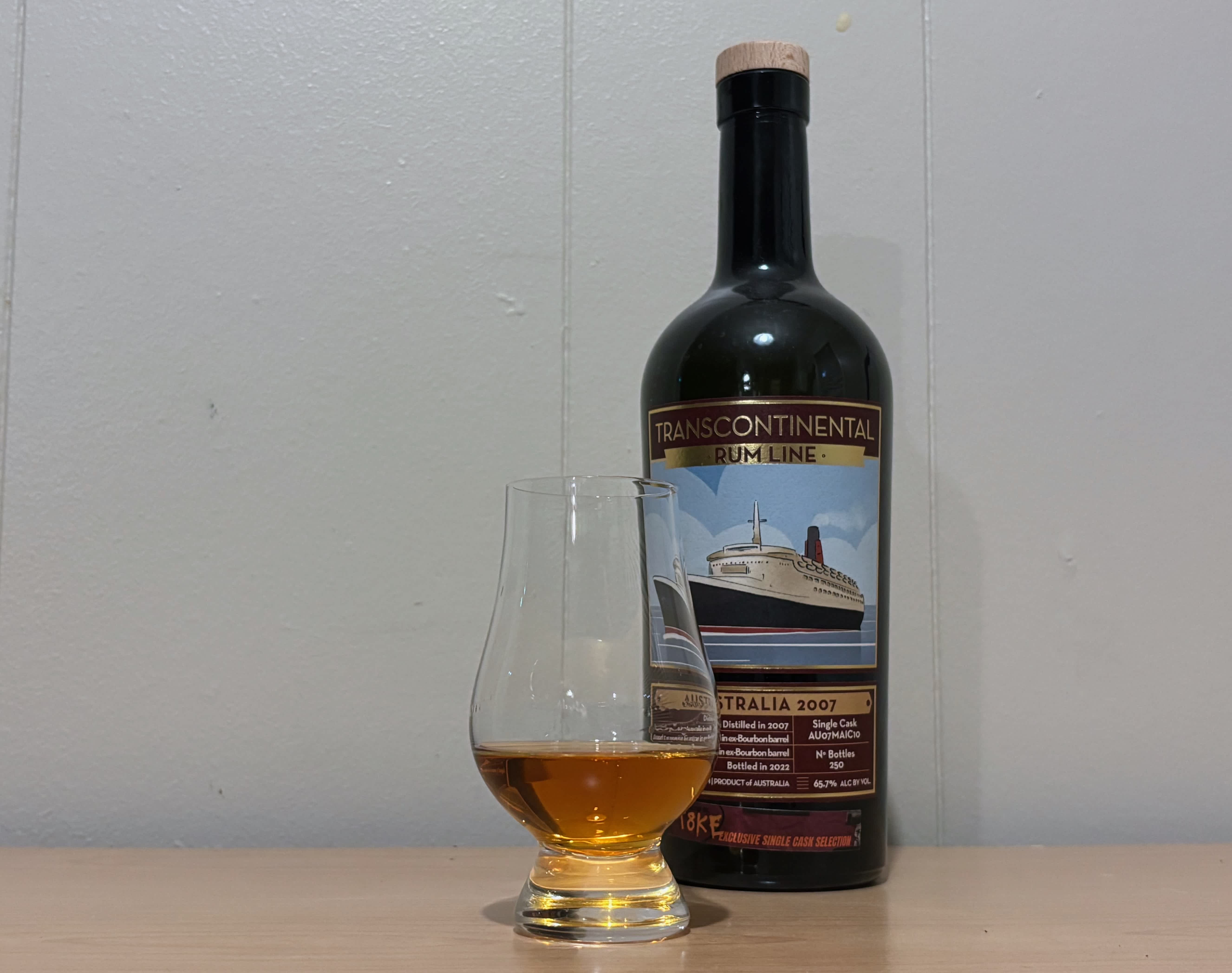 A bottle of Transcontinental Rum Line Australia 2007 Single Cask next to a glass of rum