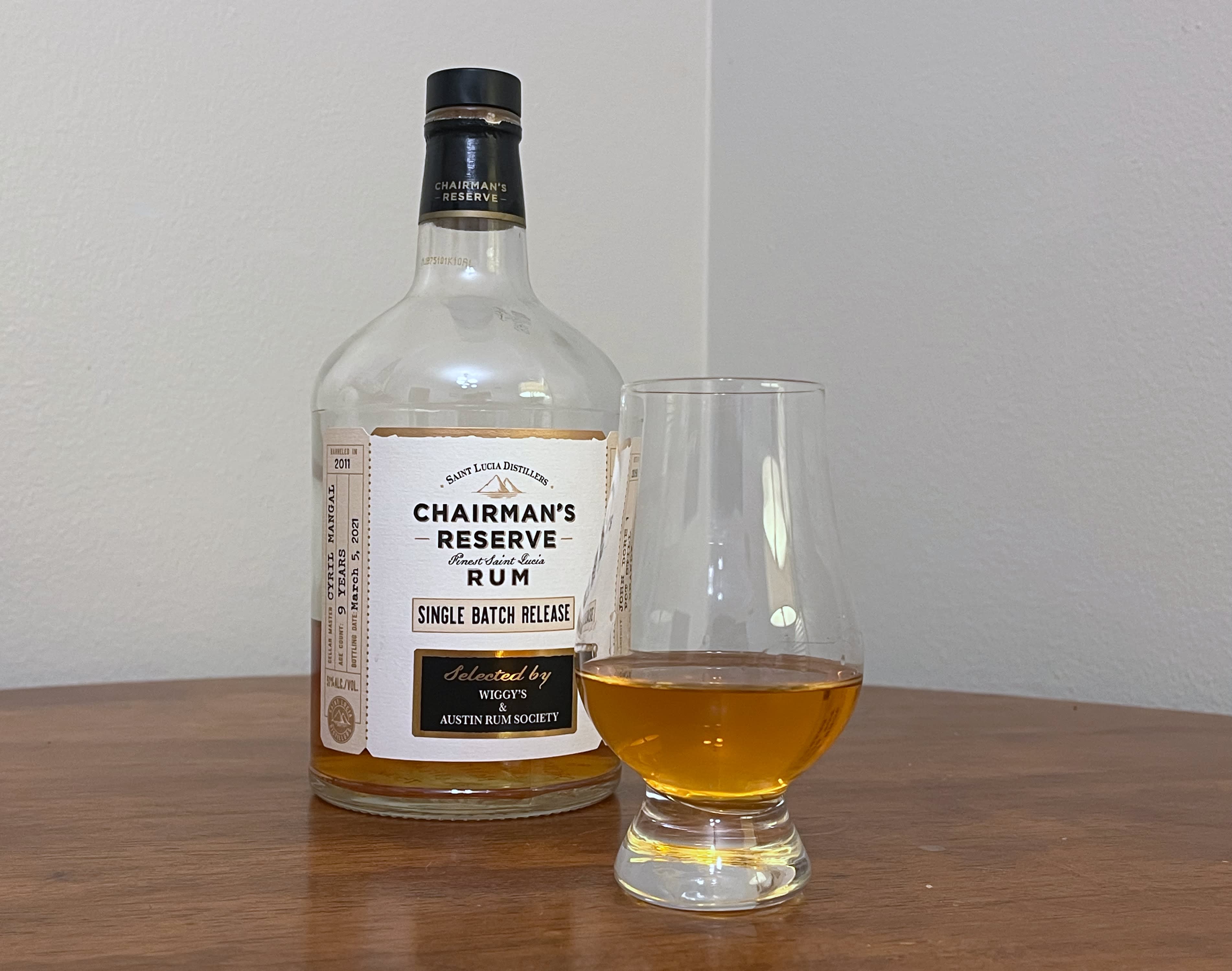 A bottle of Chairman's Reserve Single Batch 9 year - Austin Rum Society pick next to a glass of rum