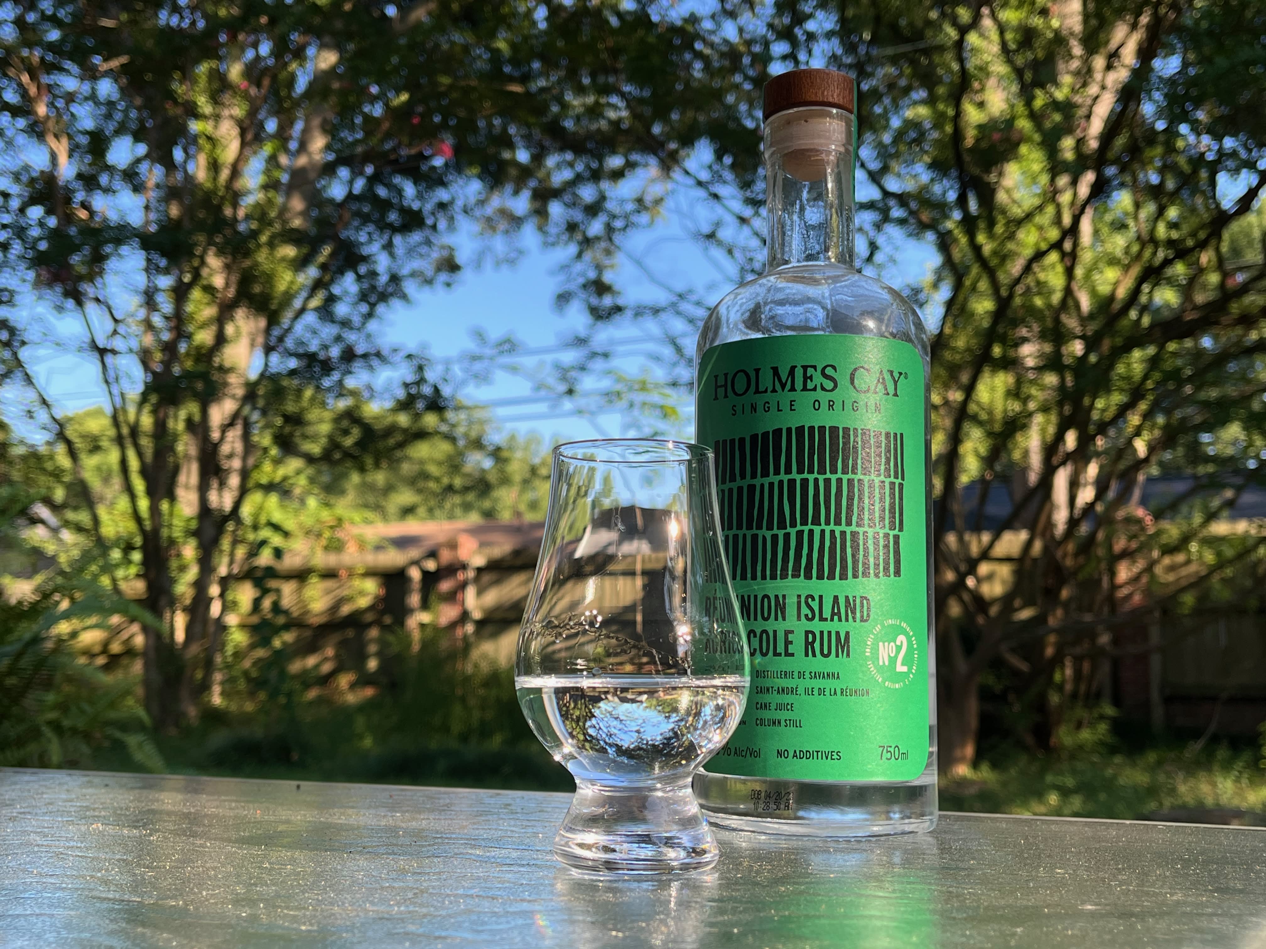 A bottle of Holmes Cay Réunion Island Agricole next to a glass of rum