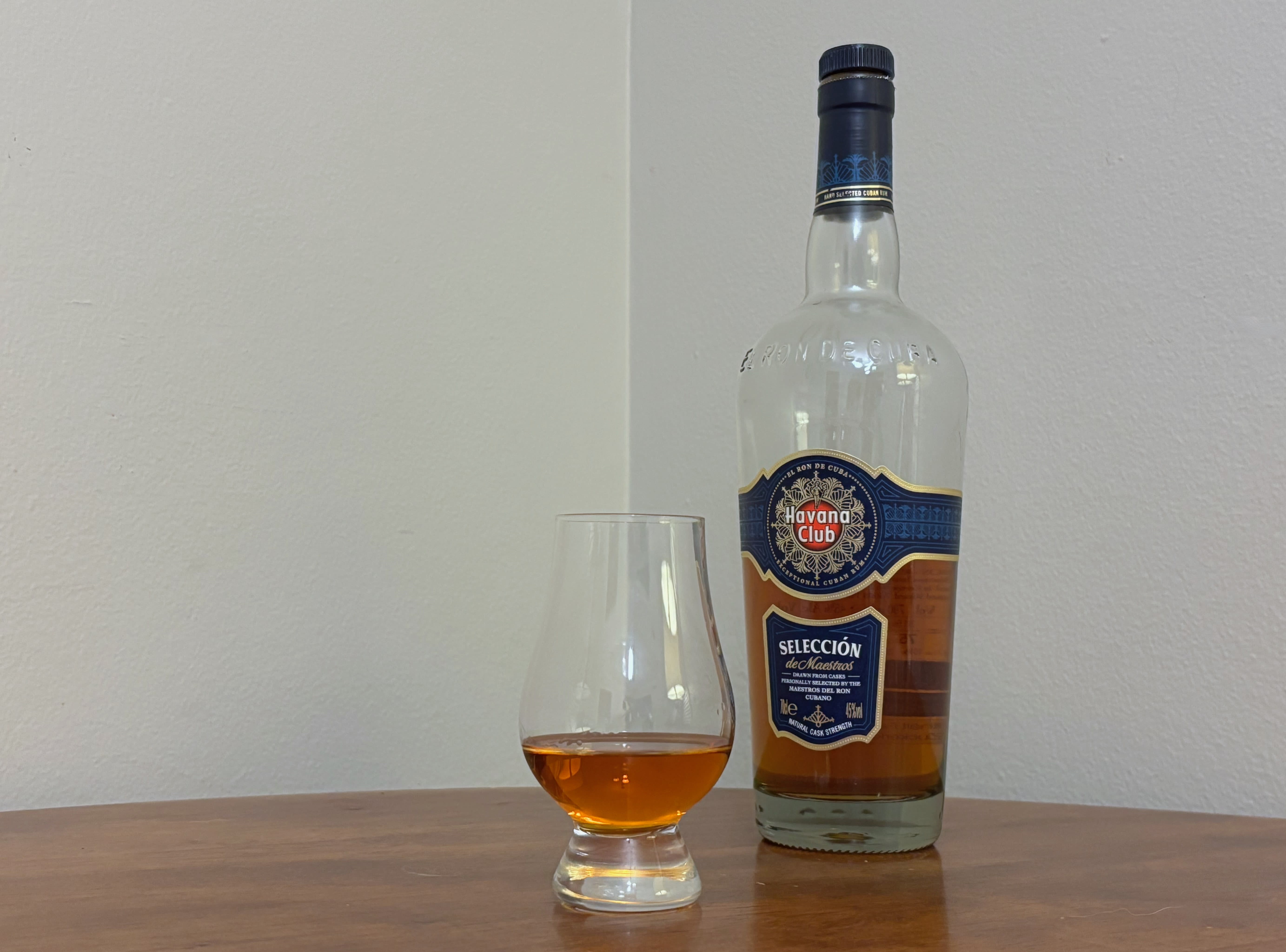 A bottle of Havana Club Selección de Maestros next to a glass of rum