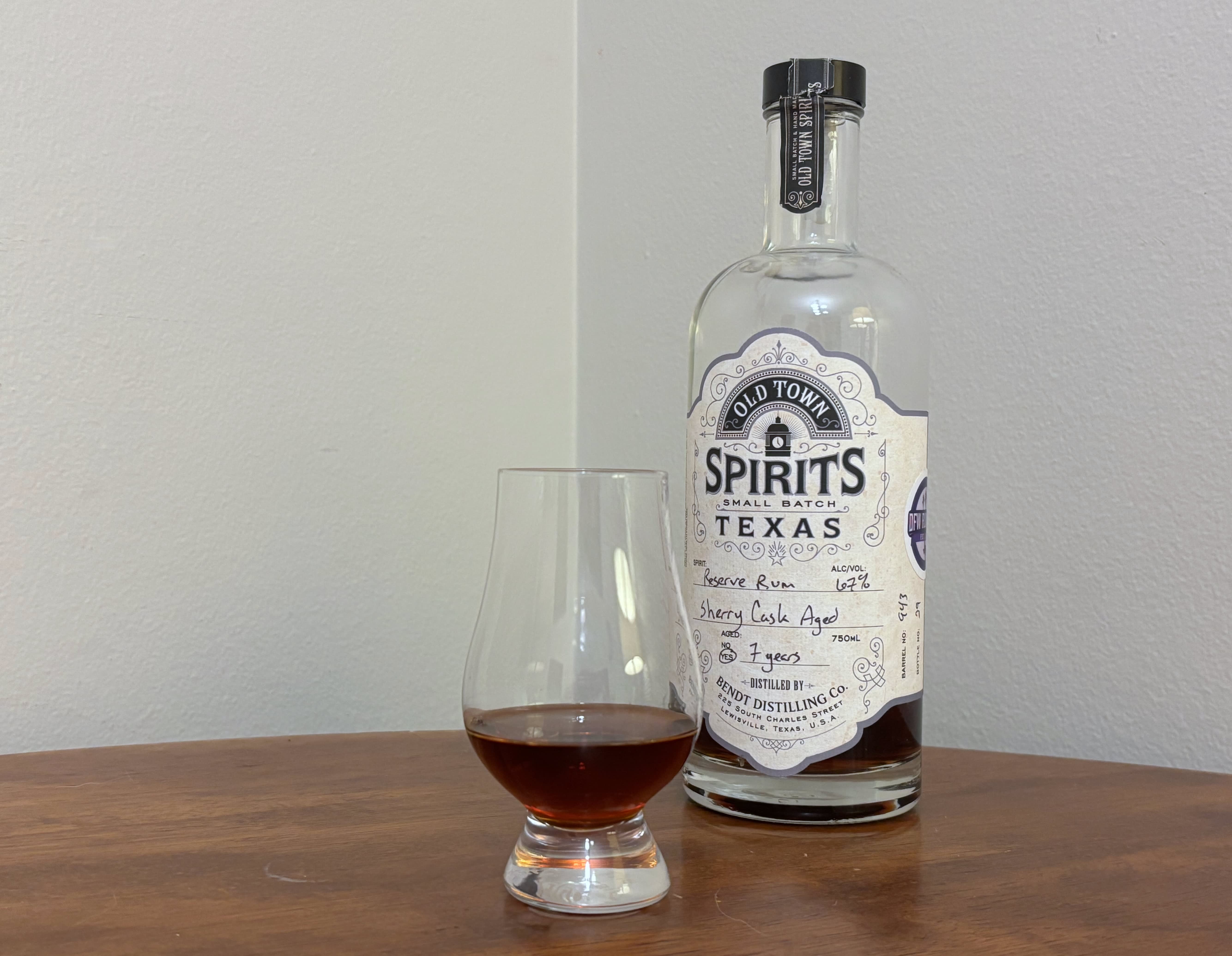 A bottle of Old Town Spirits 7 year Sherry Cask next to a glass of rum