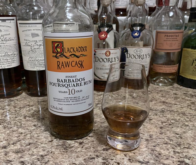 Blackadder Raw Cask Foursquare 10 year bottle next to a glass of rum