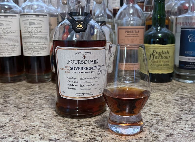 A bottle of Foursquare Sovereignty next to a glencairn of rum