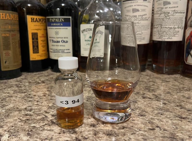 Sample bottle of Appleton Hearts 1994 on a counter next to a glencairn with rum poured in it
