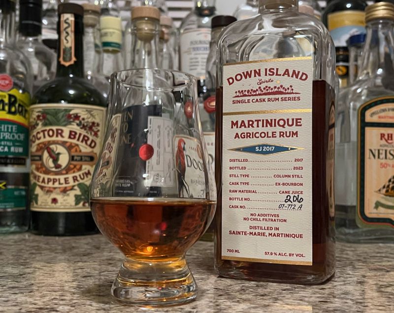 Down Island Spirits SJ 2017 bottle next to a glass of rum