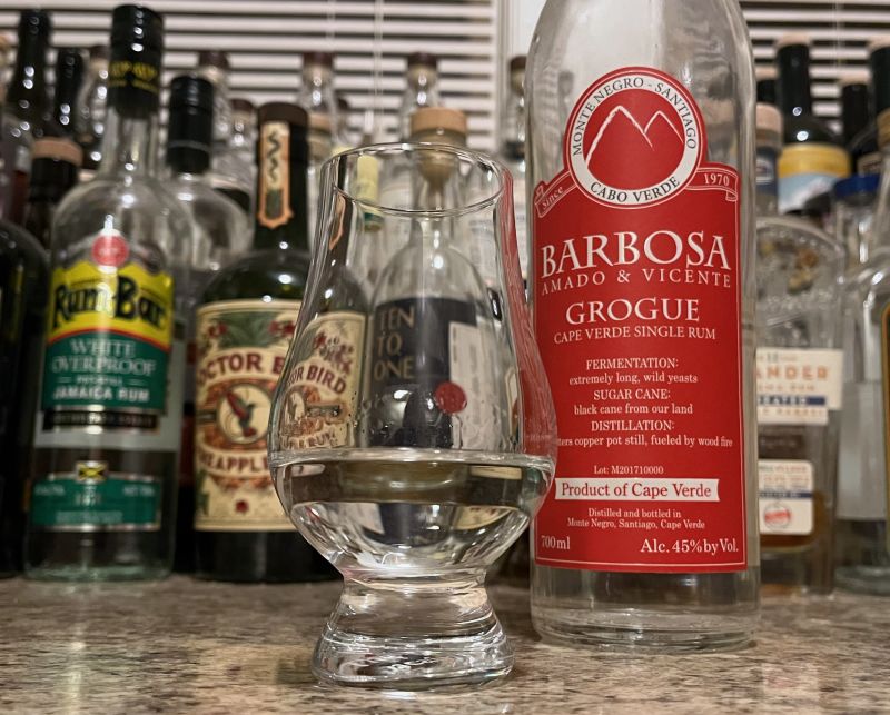 Grogue bottle next to a glass of rum