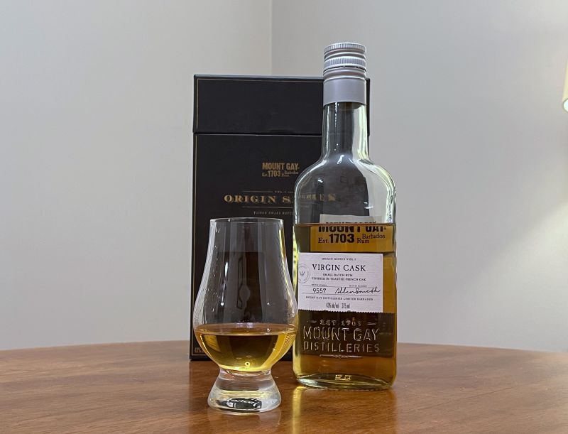 A bottle of Mount Gay Origin Series Virgin Cask next to a glencairn of rum on a kitchen counter