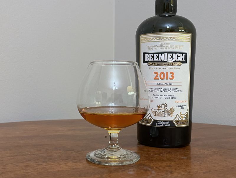 A bottle of Beenleigh 2013 10 year next to a glass of rum