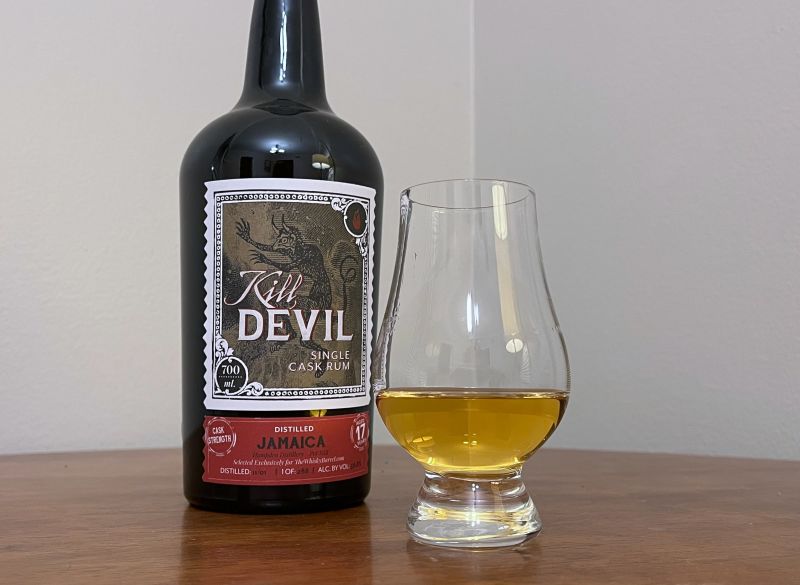 A bottle of Kill Devil Jamaica 2001 17 year next to a glass of rum