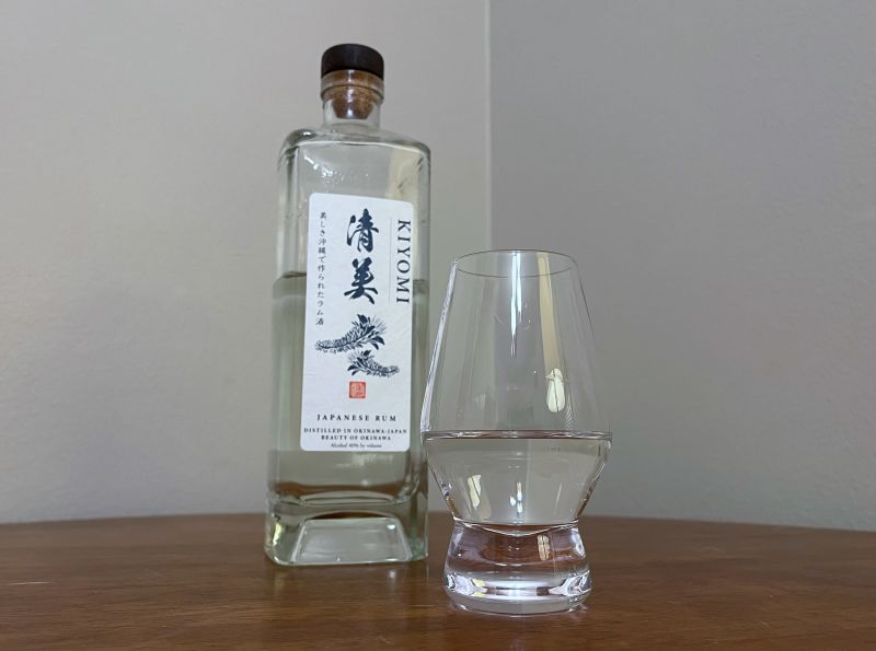 A bottle of Kiyomi Japanese Rum next to a glass of rum