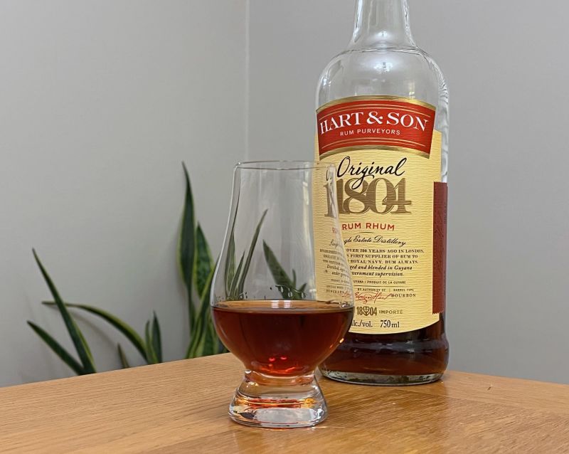 A bottle of Lemon Hart & Son Original 1804 next to a glass of rum