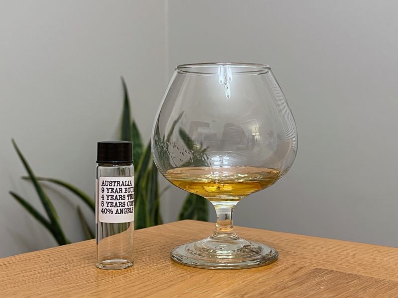 A bottle of Dead Reckoning Australia 9 year next to a glass of rum