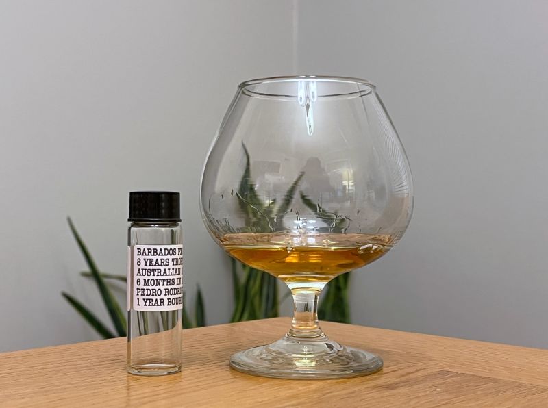 A bottle of Dead Reckoning Barbados PX Cask next to a glass of rum