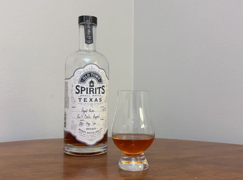 A bottle of Old Town Spirits 7 year Port Cask next to a glass of rum