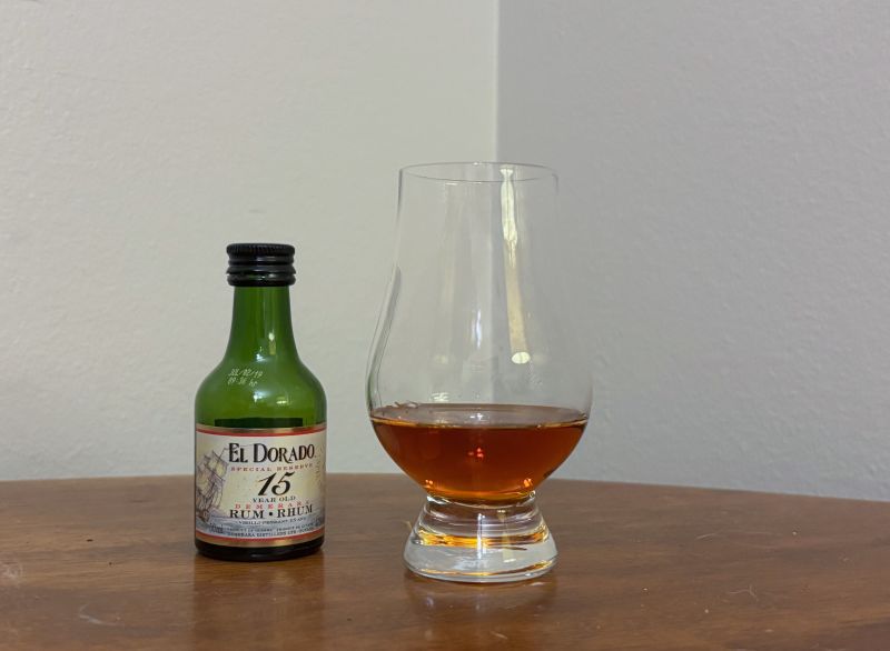 A bottle of El Dorado 15 year next to a glass of rum