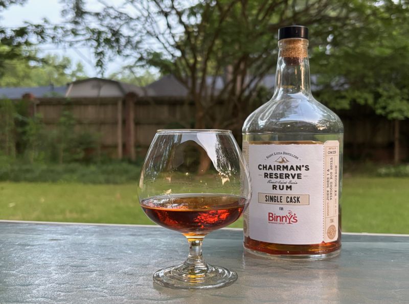A bottle of Chairman's Reserve Single Cask - Binny's 15 year next to a glass of rum