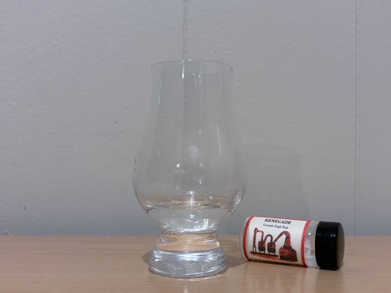 A bottle of Habitation Velier Renegade next to a glass of rum