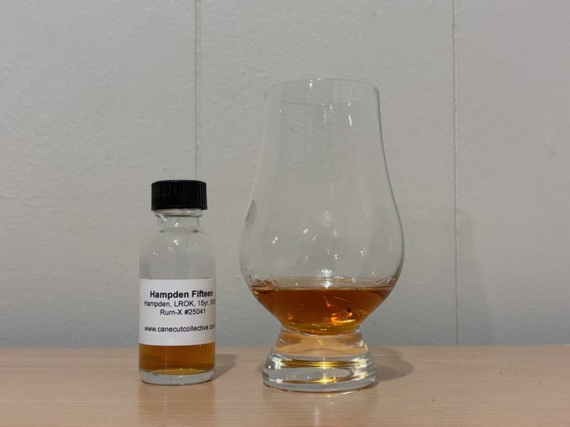 A bottle of Hampden Estate 15yr next to a glass of rum