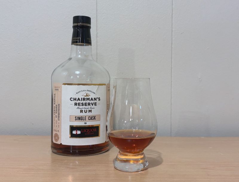 A bottle of Chairman's Reserve Single Cask - Liquor Lineup 17yr next to a glass of rum