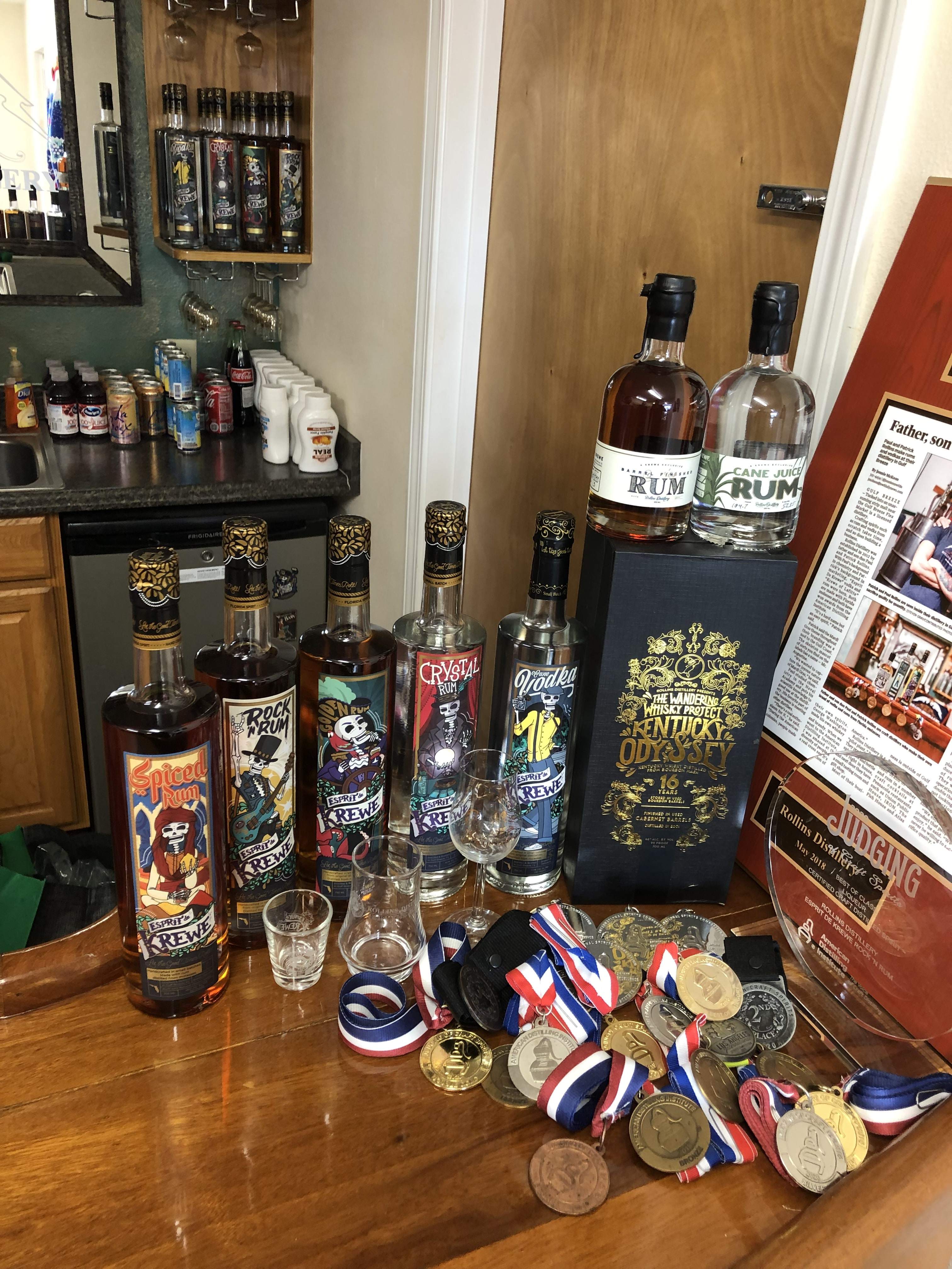 Rum bottles stacked on a wooden bar top
