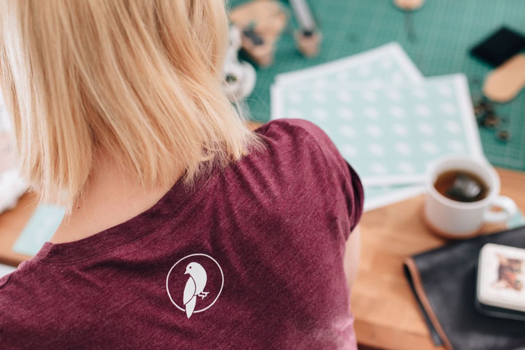 Made By Maria bird logo printed onto a heather burgundy t-shirt