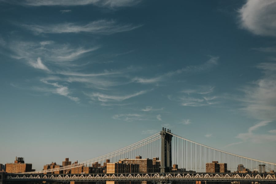 Manhattan bridge from the side with a clear blue sky above