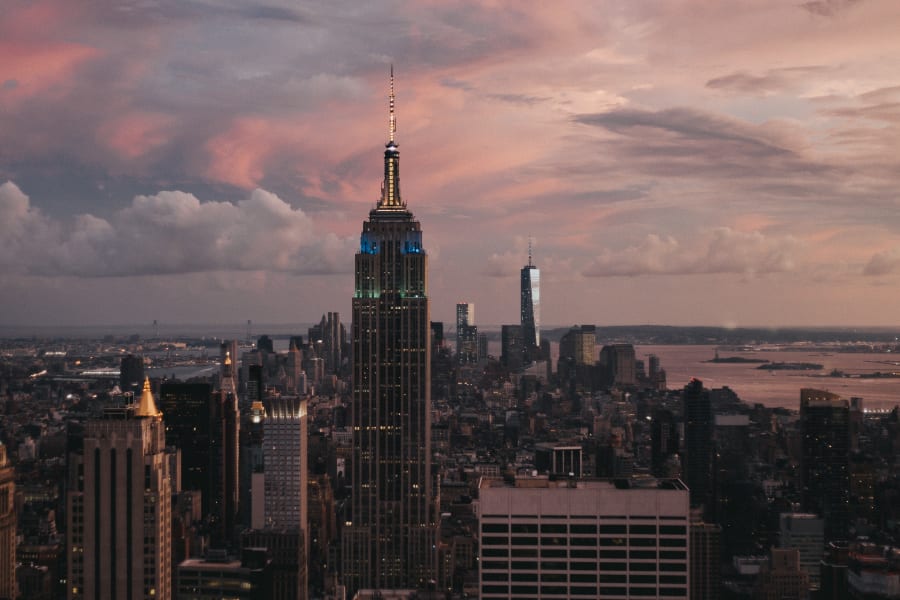 A red sky at dusk overlooking Manhattan including the Empire State building and One World Trade Center. Photo taken from Top Of The Rock