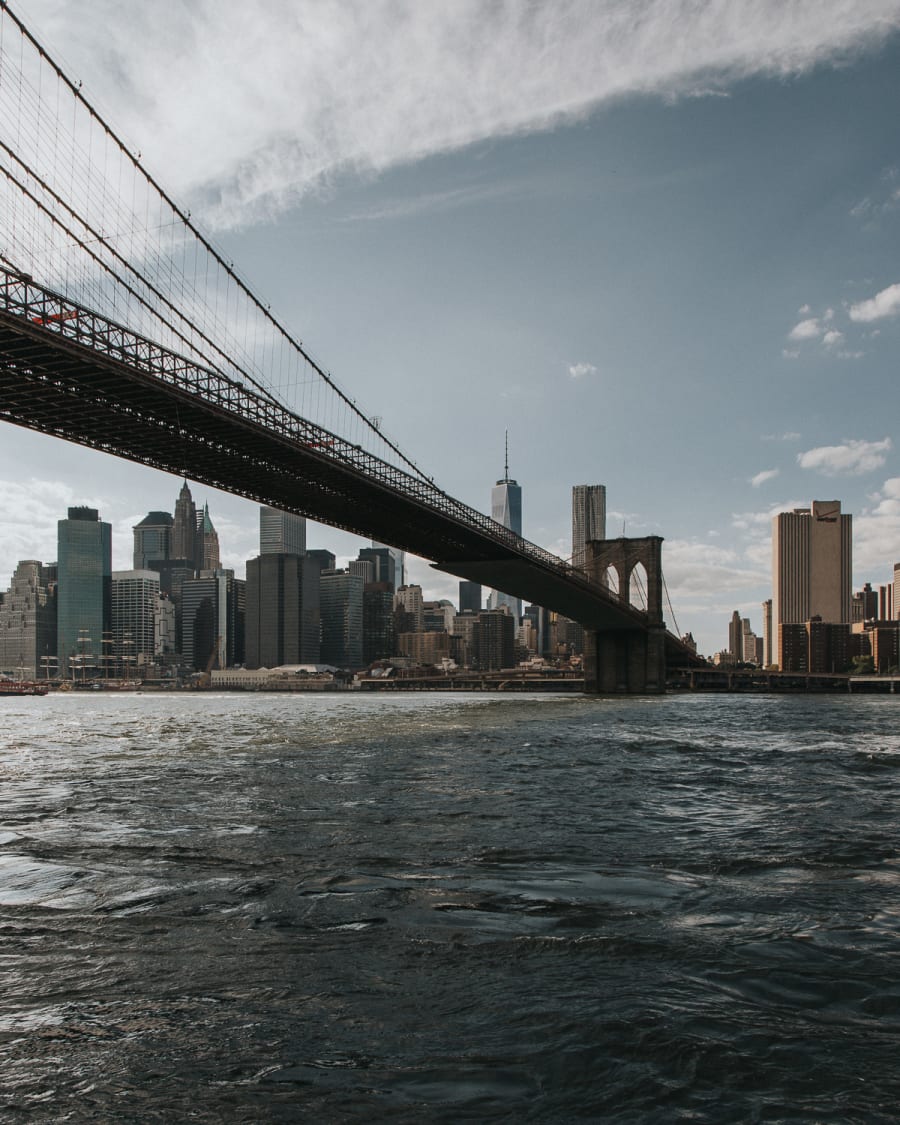 A view from Brooklyn overlooking Manhattan featuring the underside of Brooklyn Bridge