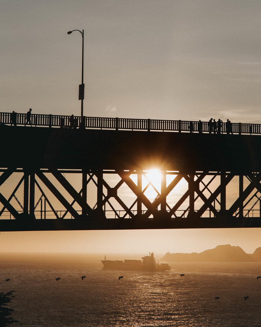 Sunset through the side of the Golden Gate Bridge in San Francisco