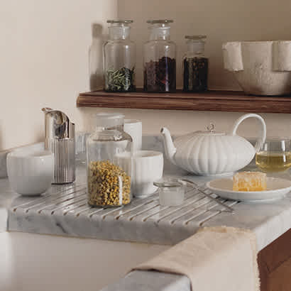 teapot cups and plate in white porcelain and milk jug in stainless steel from the bernadotte collection by georg jensen