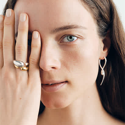 long earrings and rings in sterling silver and 18 karat yellow gold from the mercy collection on model