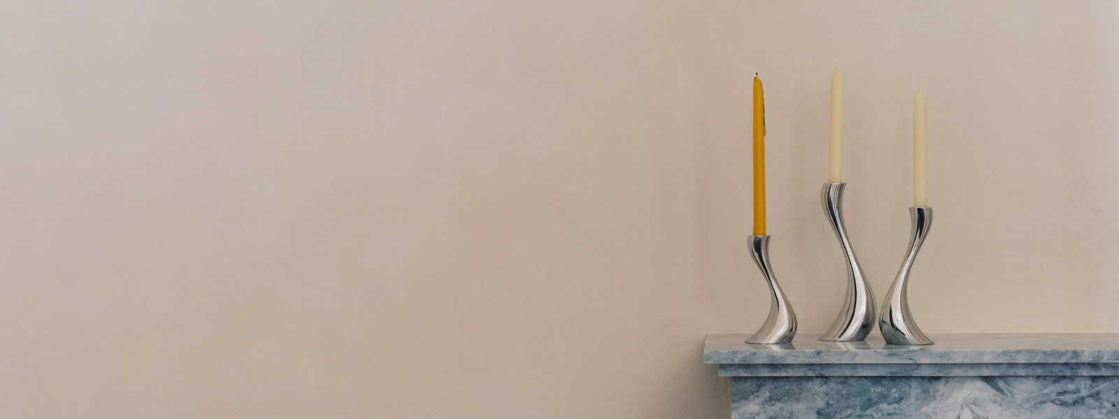 Mirror polished stainless steel candle holders from the Cobra collection