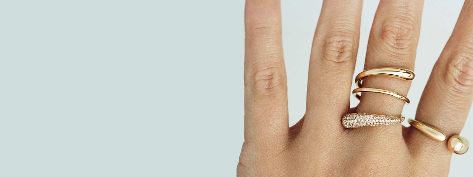 two mercy rings in 18 karat yellow gold with diamonds on hands for georg jensen