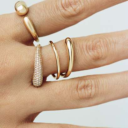 rings in 18 karat yellow gold with diamonds from the mercy collection on hand by georg jensen