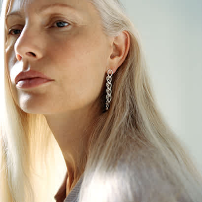 earrings in sterling silver from the weft collection by georg jensen on model