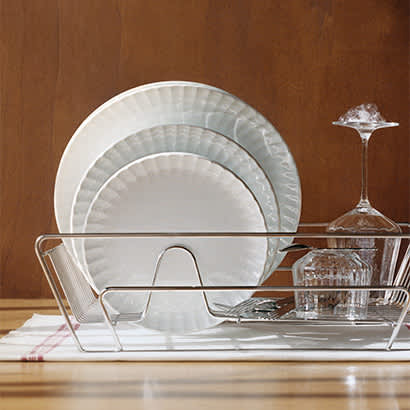 three plates in porcelain and wine glass on rack from the bernadotte collection by georg jensen