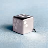 Dice in sterling silver and an ant against blue background