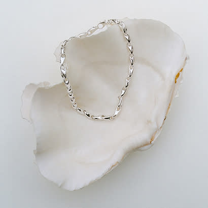 Sterling silver bracelet on a shell