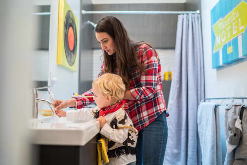 Mother and son rinsing toothbrush