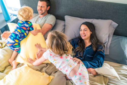 family playing in bed