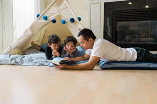 Father and his children camping indoors