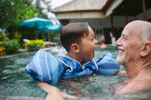 Grandfather and his grandson having a pool day