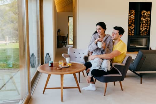 Young couple looking outside window