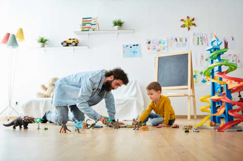 Dad playing with dinosaurs with son